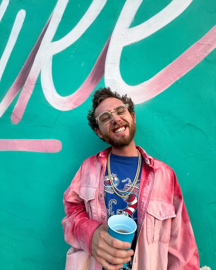 Mr B in front of a mural